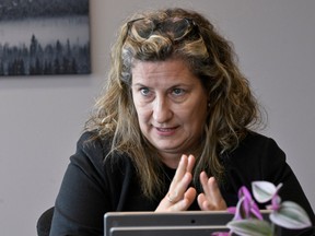 Ariane Mignolet gestures as she speaks in an office