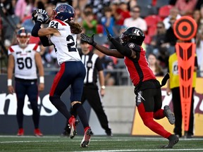 Alouettes safety Marc-Antoine Dequoy intercepts the ball in front of Redblacks' Bralon Addison before returning it 108 yards for a touchdown in September.