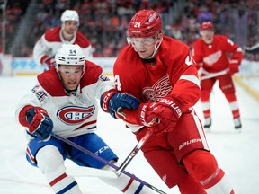 Montreal Canadiens defenseman Jordan Harris (54) battles with Detroit Red Wings center Klim Kostin (24) for the puck in the second period of an NHL hockey game Thursday, Nov. 9, 2023, in Detroit.
