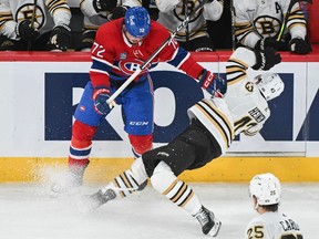 Canadiens' Arber Xhekaj (72) checks Boston Bruins' Danton Heinen in Montreal, on Nov. 11, 2023.