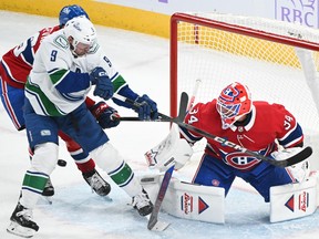 Vancouver Canucks' J.T. Miller (9) moves in on Montreal Canadiens goaltender Jake Allen during first period NHL hockey action in Montreal on Sunday, Nov. 12, 2023.