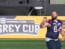 Montreal Alouettes' offensive lineman Sean Jamieson (64) plays with a Frisbee during a walkthrough in Hamilton, Ont., on Saturday, Nov. 18, 2023. The Alouettes will take on the Winnipeg Blue Bombers in the 110th CFL Grey Cup on Sunday, Nov. 19, 2023. 