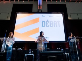 Candidate Ruba Ghazal, right, speaks as fellow candidates Emilise Lessard-Therrien, centre, and Christine Labrie look on during a debate at the Québec solidaire party convention