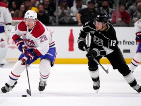 Canadiens' Christian Dvorak (28) skates past Los Angeles Kings' Trevor Moore (12) on Saturday, Nov. 25, 2023, in Los Angeles.