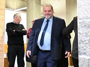 Quebec provincial police say two men have been charged with violating a publication ban after allegedly revealing the identity of a woman who was sexually assaulted by a former member of the legislature. Former Parti Québécois MNA Harold LeBel walks to the courtroom after a break at the courthouse, in Rimouski, Que., Monday, Nov. 14, 2022. LeBel was sentenced to eight months in jail for the sexual assault.