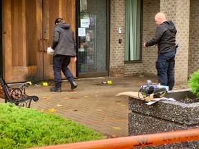 Investigators inspect the scene following a firebombing at a West Island synagogue