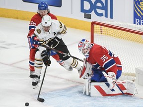 Canadiens' Michael Pezzetta (55) defends against Boston Bruins' David Pastrnak as he moves in on Canadiens goaltender Sam Montembeault during first period NHL hockey action in Montreal on Saturday, Nov. 11, 2023.