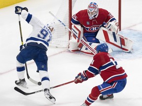 Lightning's Steven Stamkos takes a shot to the right of Canadiens goaltender Sam Montembeault while captain Nick Suzuki backchecks during Tuesday night's game at the Bell Centre.