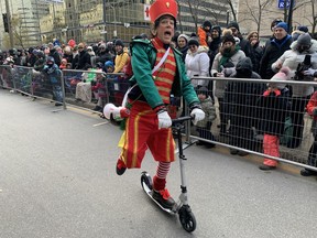There are other forms of transportation other than a sleigh pulled by reindeers as this Christmas elf demonstrates at the 71st Santa Claus parade on Saturday, Nov. 25, 2023.