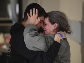 This handout photo provided by Haim Zach/GPO shows Sharon Hertzman, right, hugging a relative as they reunite at Sheba Medical Center in Ramat Gan, Israel, Saturday Nov. 25, 2023