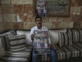 With the world’s eyes on Gaza, attacks are on the rise in the West Bank 7 Abdelazim Wadi, 50, holds up a poster commemorating his brother, Ibrahim Wadi, and his nephew, Ahmed Wadi.