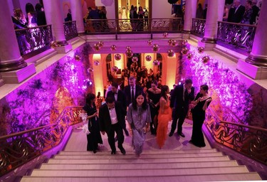 Glam guests, including American Iron & Metal group chief financial officer Richard Pan and his wife, MMFA board member Clare Chiu, vice-president of Warwick Hotels and Resorts (foreground), make their way into the Montreal Museum of Fine Arts Ball on Saturday, November 18, 2023.