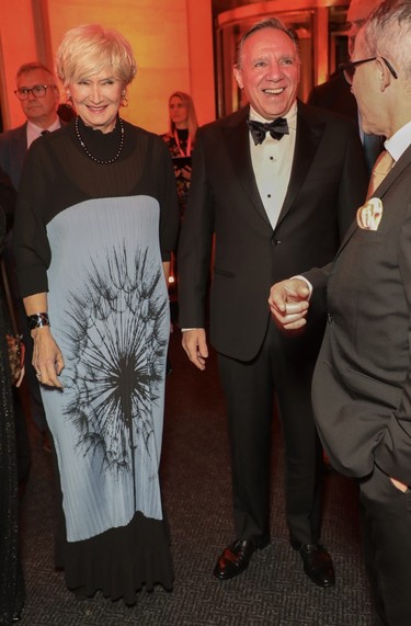 Quebec premier François Legault makes his way into the recent MMFA ball with wife Isabelle Brais.