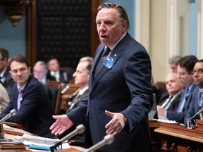 Premier François Legault stands in the National Assembly in Quebec City to respond to opposition questions.