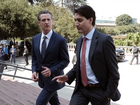 Prime Minister Justin Trudeau, right, arrives with California Gov. Gavin Newsom prior to signing a memorandum of co-operation on climate change at the California Science Center outside the ninth Summit of the Americas, in Los Angeles, on Thursday, June 9, 2022.