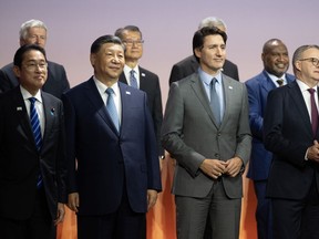 Prime Minister Justin Trudeau stands next to Chinese President Xi Jinping and other leaders for the family photo at the APEC Summit, in San Francisco, Calif., Thursday, Nov. 16, 2023.