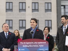 Prime Minister Justin Trudeau, centre, makes a housing announcement with Quebec Premier François Legault, left, in Longueuil, Thursday Nov. 9, 2023.