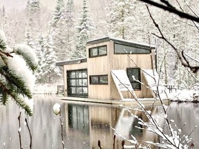 A floating, two-storey chalet in winter.