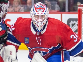 Canadiens goalie Jake Allen is seen in a close-up peering out from his net.