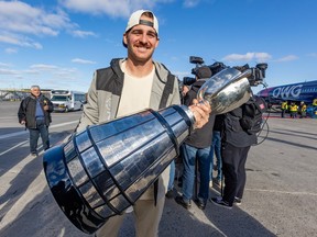 Alouettes Quarterback Cody Fajardo carries the Grey Cup after the CFL champions arrived at Mirabel airport on Nov. 20.