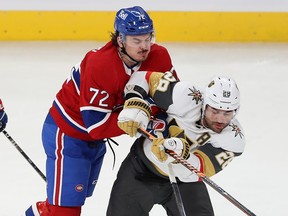 Canadiens' Arber Xhekaj collides at mid-ice with Golden Knights' William Carrier during a game last month at the Bell Centre.