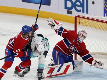 Canadiens goaltender Sam Montembeault reaches back from the side of the net