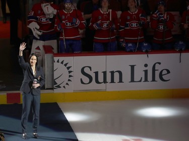 Caroline Ouellette waves while on a carpet on the ice at the Bell Centre