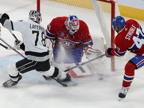 Canadiens goaltender Sam Montembeault stops Kings' Alex Laferrière in the crease while defenceman Jayden Struble tries to wrap up the Kings forward's stick Thursday night at the Bell Centre.
