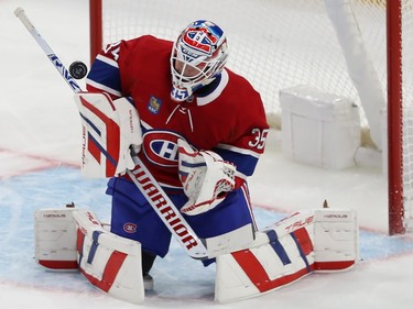 Canadiens goaltender Sam Montembeault stops a shot with his blocker in front of the net