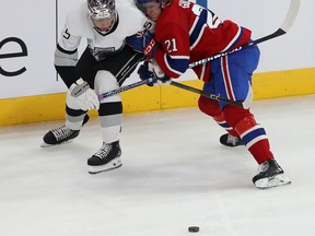 Quinton Byfield (55) and Montreal Canadiens' Kaiden Guhle (21) during first period NHL action in Montreal.