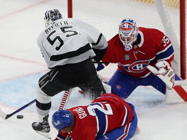 A Kings player has the puck in front of his stick just outside the Montreal crease