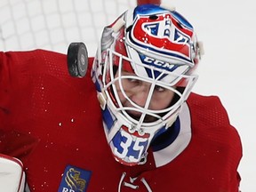 A close-up shot shows the puck right next to the masked face of Canadiens goalie Sam Montembeault