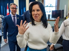 Montreal mayor valerie plante is gesturing with her hands up beside her shoulders at a press conference.
