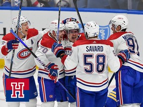 A group of hockey players celebrates a goal