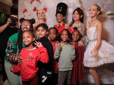 -oungsters from the Côte-des-Neiges Black Community Association pose for a photo with a group of dancers from The Blonde Ballet Entertainment group at a special holiday event called One Magic Moment in Montreal on Sunday, Dec. 17, 2023. Dancers from the left are: Laurence Beaudry-Jodoin, Victoria Fils-Aimé, Vickey Smookie and Andreanne Mercier. In front from the left are volunteer Neziah Olivier-Antoine, Nyla (no last name), Mikail Usman, Hendrix Beache, Samaya Sutton and Brielle Joseph.