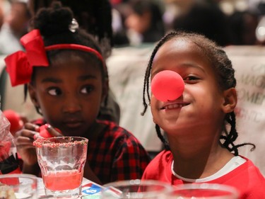 Brielle Joseph (left) looks over at Nyla (no last name given) at an event called One Magic Moment in Montreal on Sunday, Dec. 17, 2023. The special holiday event is organized for 140 children from underserved communities.