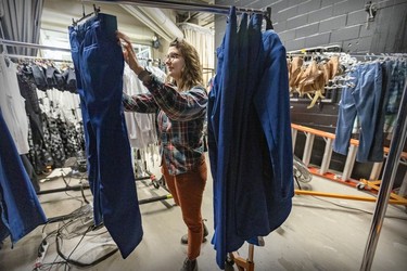 Wardrobe technician Melinda Moynihan sorts costumes backstage during rehearsals for the new Cirque du Soleil ice show Crystal at the Bell Centre in Montreal on Thursday, Dec. 21, 2023.