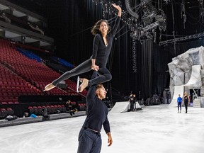 Dmitry Semykin carries Hjordis Lee with one arm during rehearsals.