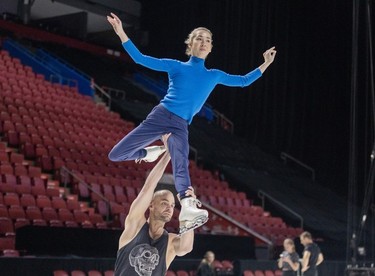 Stuart Widdall skates with Stina Martini over his head during rehearsals for the new Cirque du Soleil ice show Crystal at the Bell Centre in Montreal on Thursday, Dec. 21, 2023.
