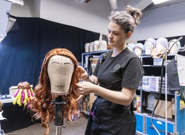 Wig technician Jessica Lowrie works backstage during rehearsals for the new Cirque du Soleil ice show Crystal at the Bell Centre in Montreal on Thursday, Dec. 21, 2023.