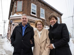 Michael Fitzgerald, executive director of the Tenaquip Foundation, with his wife, Joanne Reed, and her mother, Shirley Reed, outside the building on Dec. 8, 2023, that will be transformed into a transitional shelter in the Lachine borough of Montreal.