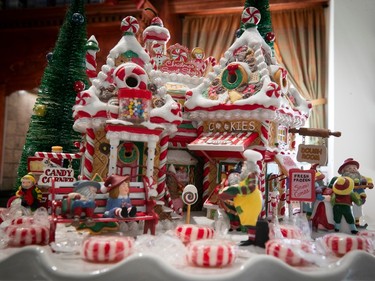 Two buildings are made of candy in a miniature Christmas village.