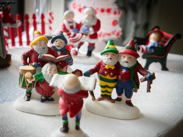 Carolers in a miniature Christmas village.
