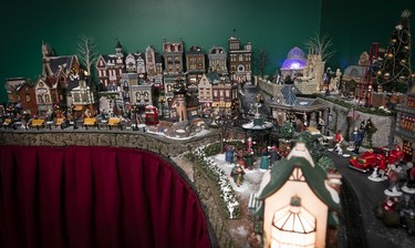 A miniature village on a long, curved table.