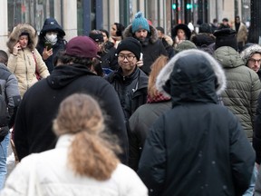 A crowd of shoppers in winter clothes.
