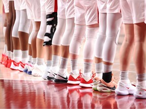 The lined up legs and feet of Team Canada members.