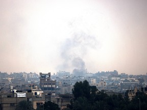Smoke rises above buildings in Khan Yunis in the southern Gaza Strip.