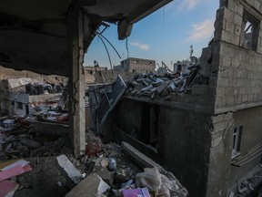 Palestinian citizens inspect the destruction caused by air strikes on their homes on Dec. 3, 2023 in Khan Yunis, Gaza.