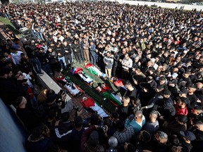 Palestinian mourners carry the bodies of men killed during an Israeli raid in the occupied West Bank, on Dec. 8, 2023, during a funeral in the village of al-Fara.