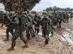 Israeli soldiers prepare to return to the Gaza Strip, near the border area in southern Israel on Dec. 13, 2023 amid ongoing battles with the Palestinian Hamas movement.
